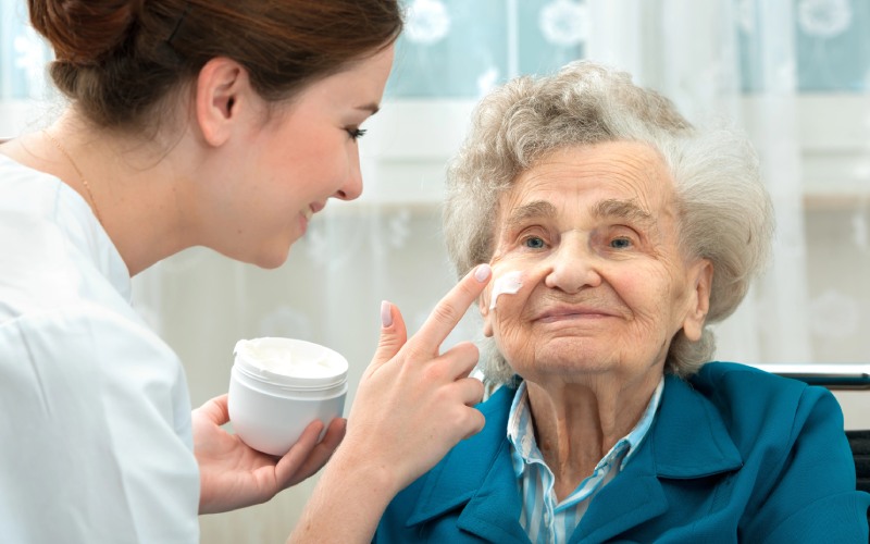 elderly woman is assisted by nurse at home