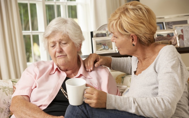 adult daughter visiting senior mother