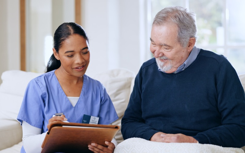 nurse-elderly-happy-man woman writing questionnaire answers client feedback