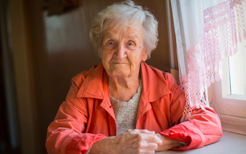 elderly woman in red jacket