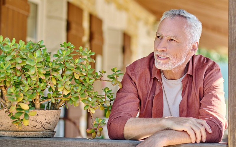 looking thoughtful mature gray haired man standing