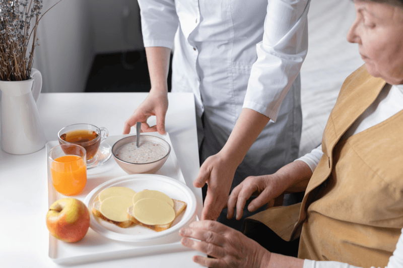 senior patient taking breakfast